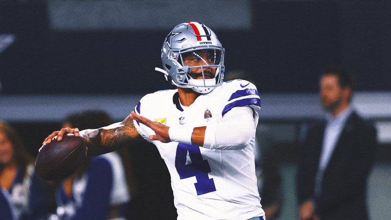 Dak Prescott smiling on the field after a Cowboys game
