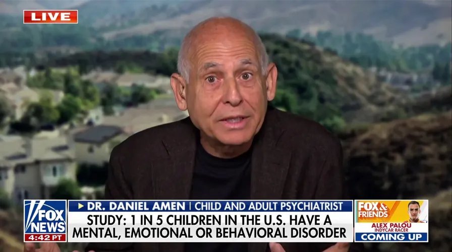 A person's hand reaching for a shower head in a dimly lit bathroom, emphasizing the calming effect of reduced light.