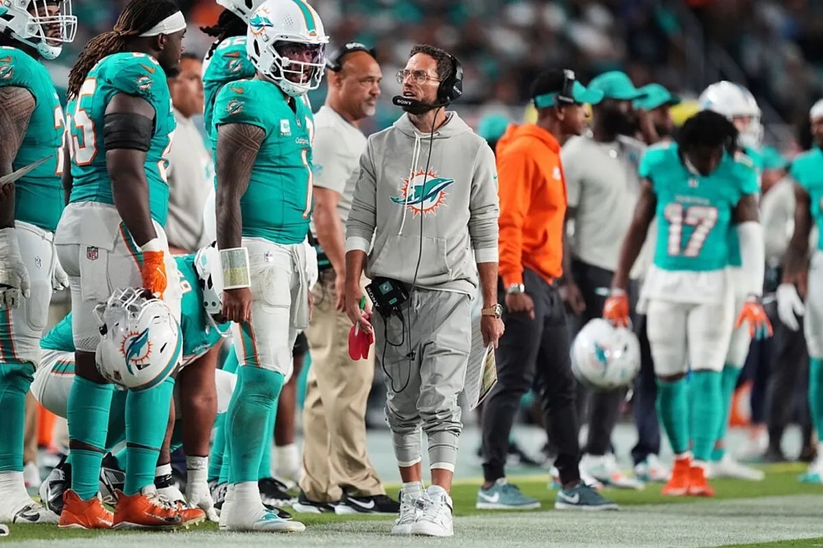 Tua Tagovailoa on the sidelines, contemplating the Dolphins' future.