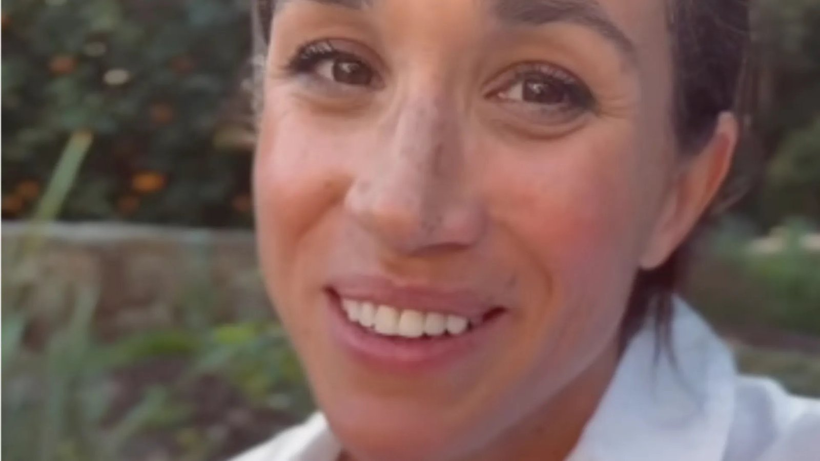 Duchess Meghan cooking or preparing a dish in a modern, elegant kitchen, hinting at the culinary focus of her special.