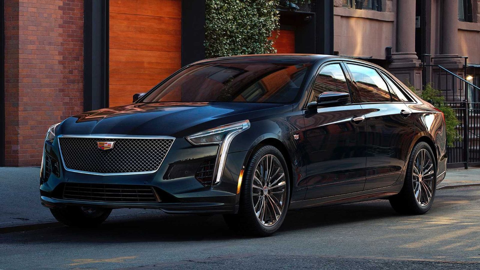 Cadillac CT6 parked on a city street at dusk, showcasing its sleek design and ambient lighting.