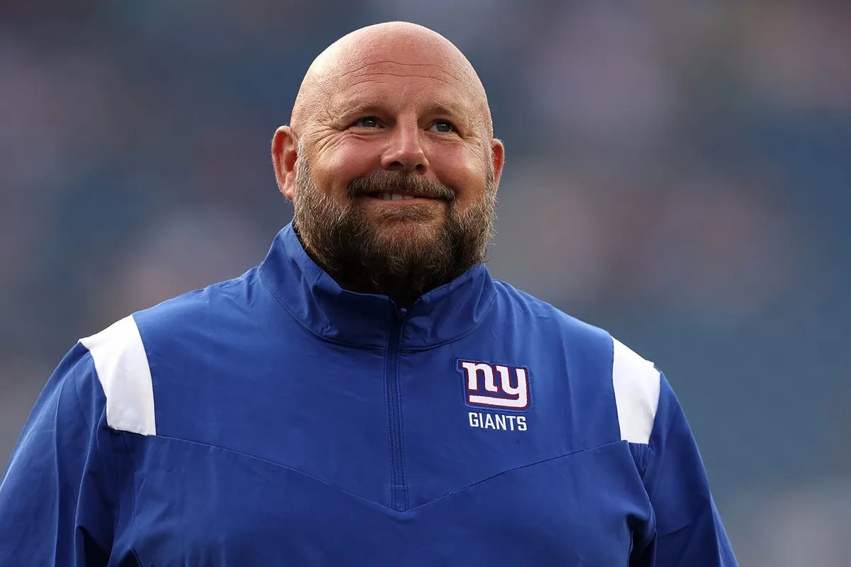 A crowded sports bar erupts in cheers, then confusion, as news of Brian Daboll's 'firing' spreads on phones.