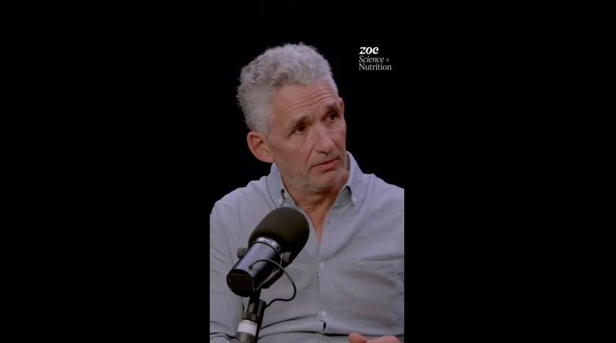 A person's hands gently cupping a warm, steaming mug of tea, conveying a sense of comfort and relaxation.