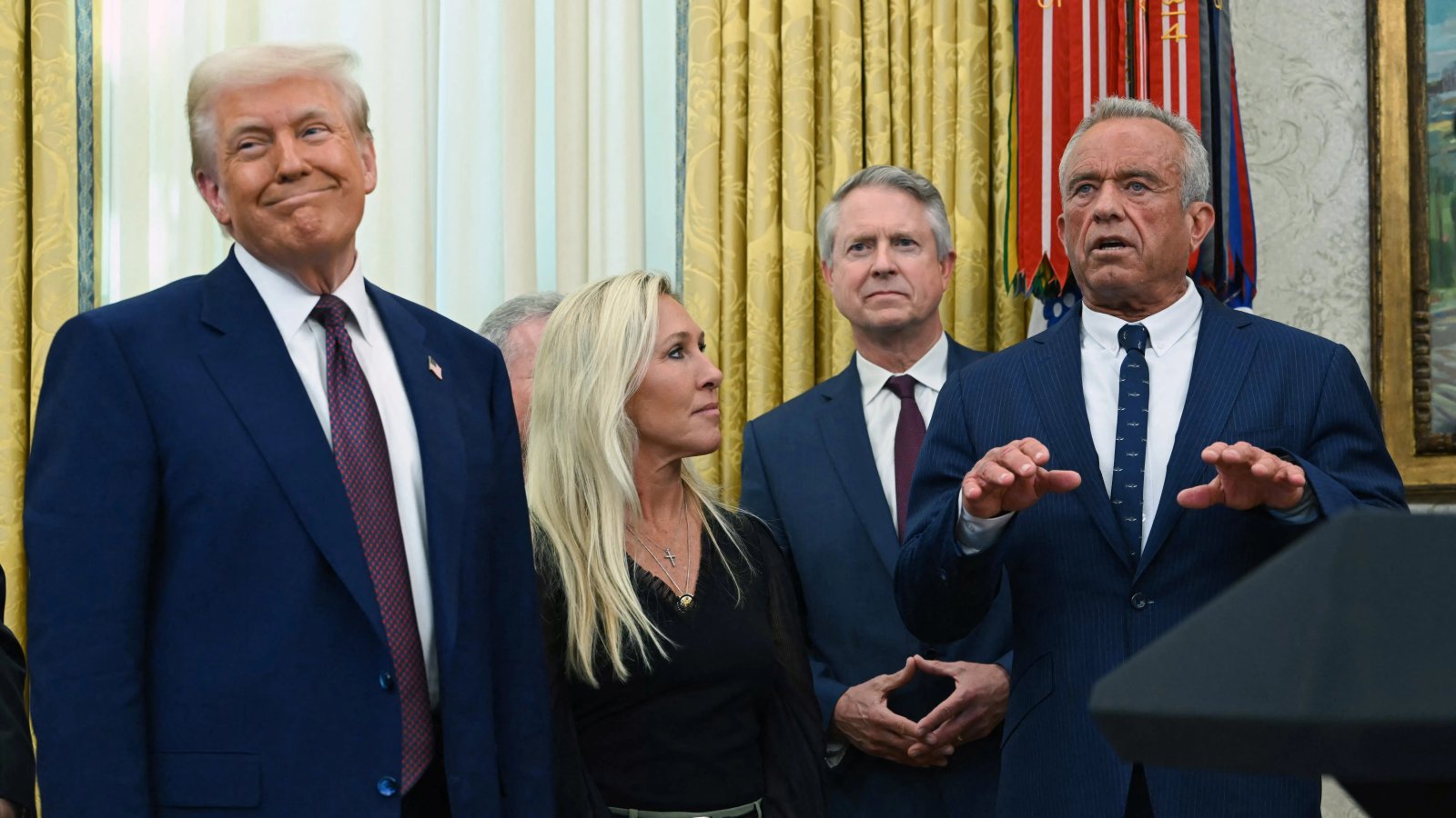 A political rally crowd with signs showing support for a leader.