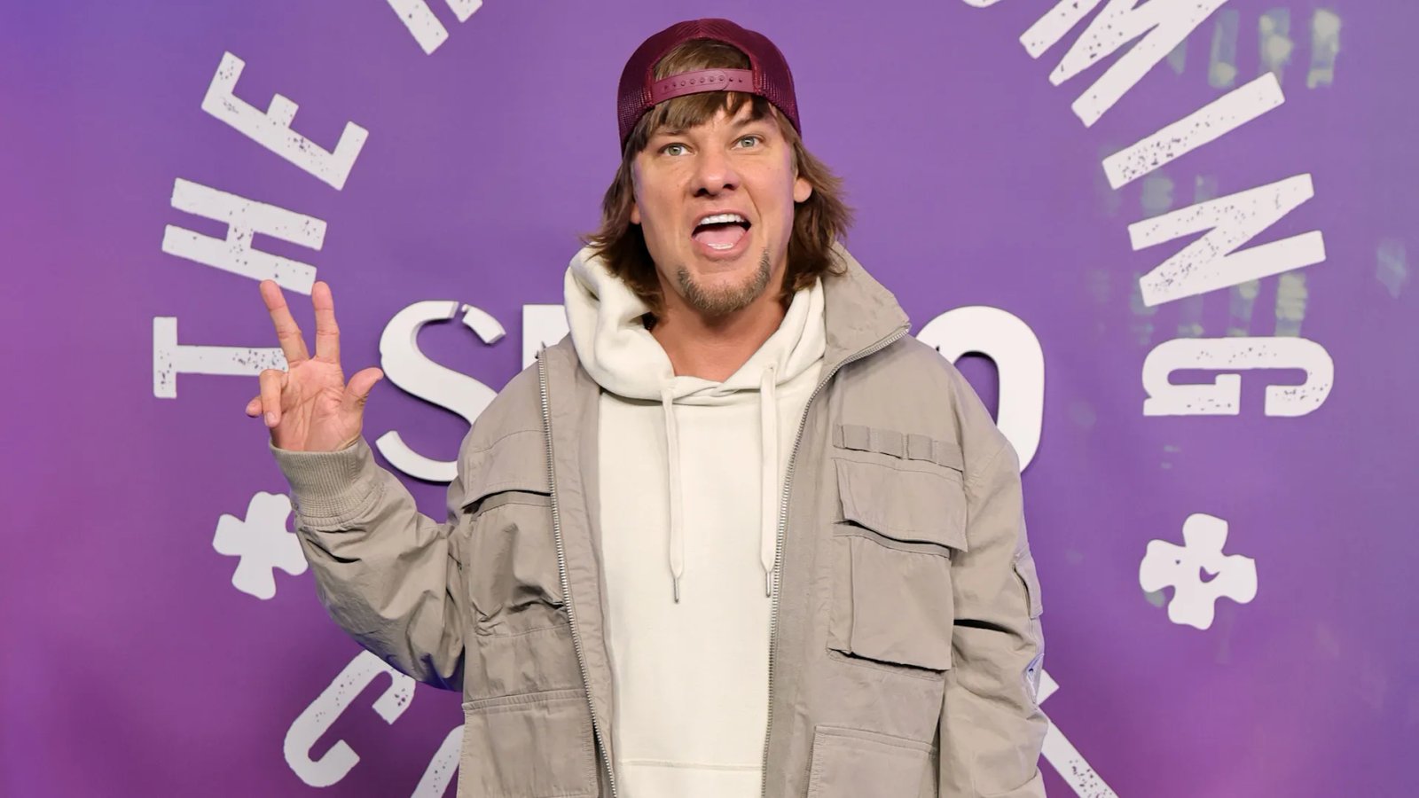 Close-up of the ICE logo on a building, blurred background.