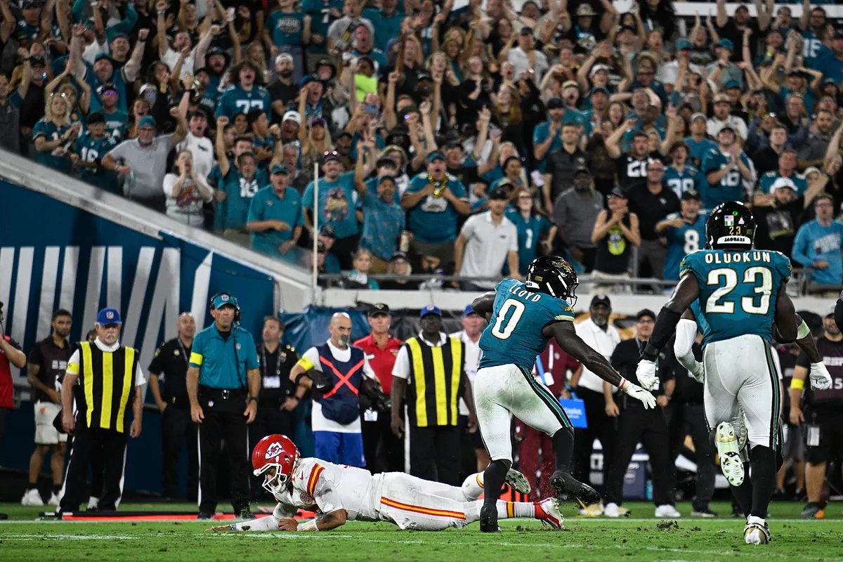 An artist's rendering of the proposed 'Stadium of the Future' for the Jacksonville Jaguars, showcasing a sleek, modern design with a protective canopy over the seating areas, set against a vibrant city skyline.