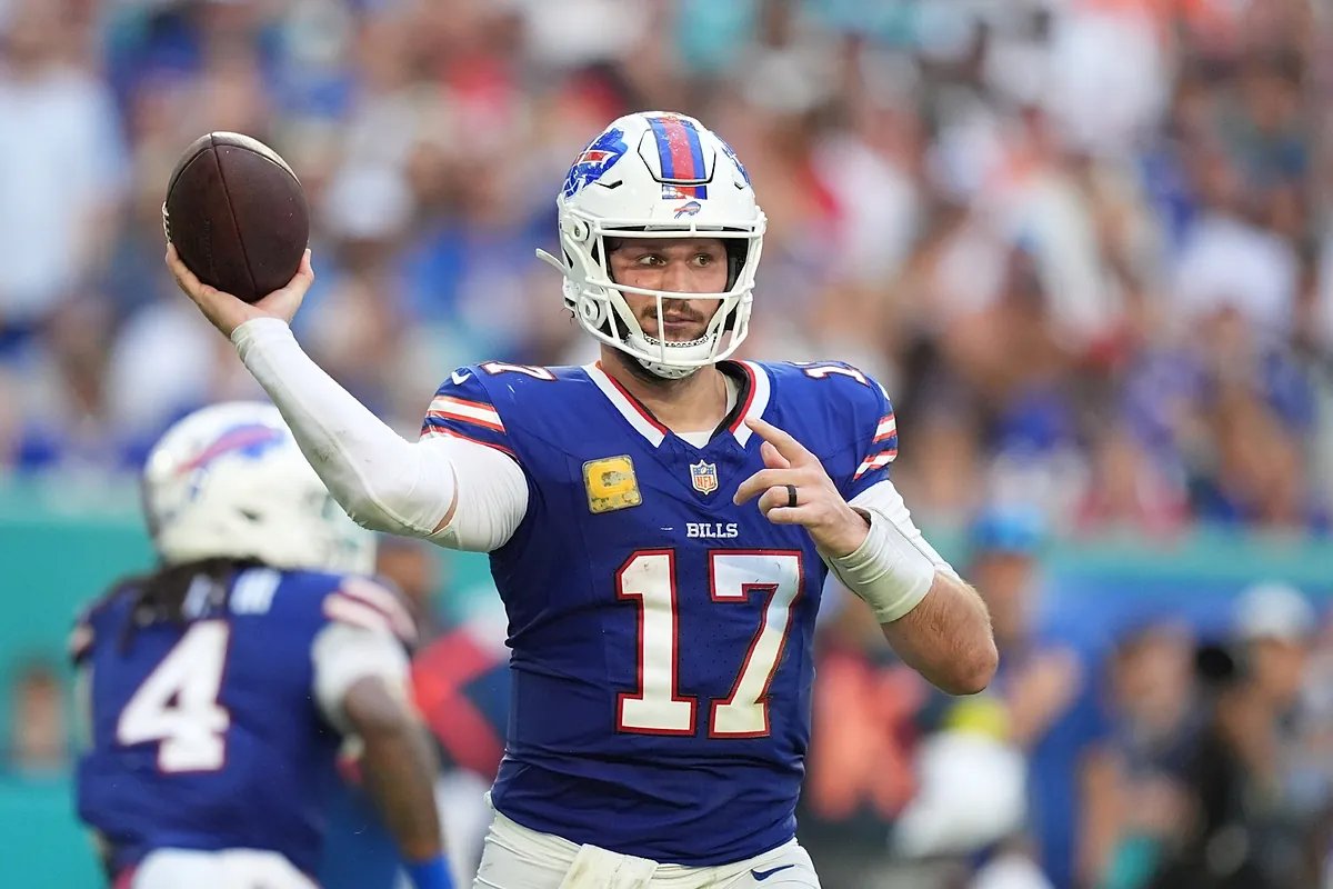Josh Allen on the sidelines during the game against the Miami Dolphins, looking frustrated.