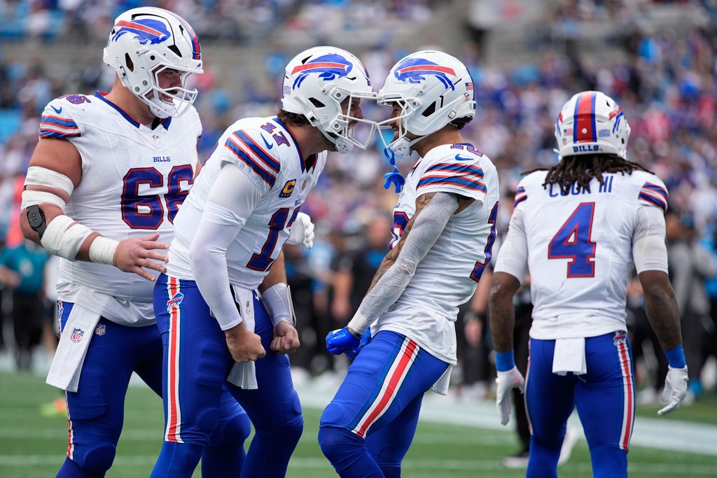 Josh Allen discussing strategy with receiver amidst performance concerns Josh Allen and a Bills receiver in a heated discussion during a game