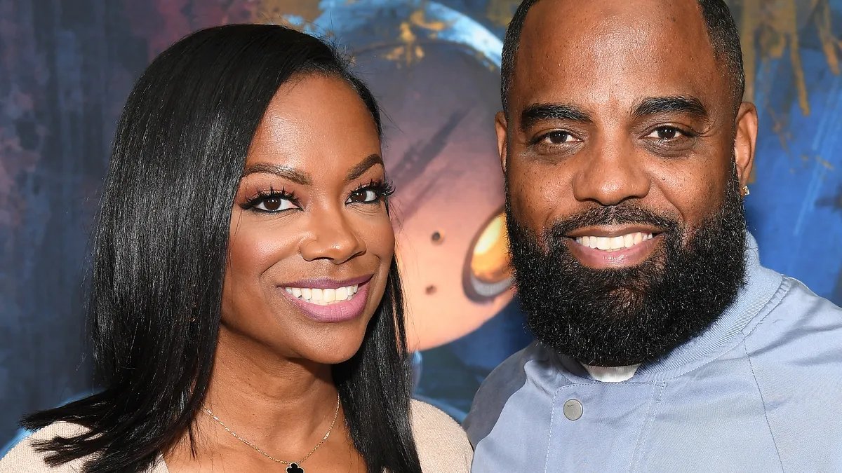 Kandi Burruss and Todd Tucker posing together at an event.