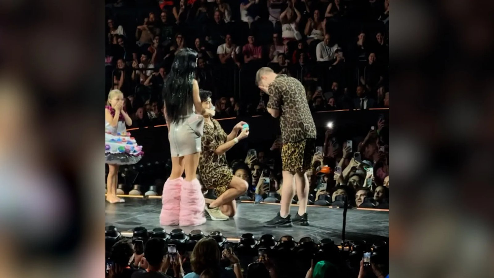 A close-up photo of Katy Perry singing into a microphone.