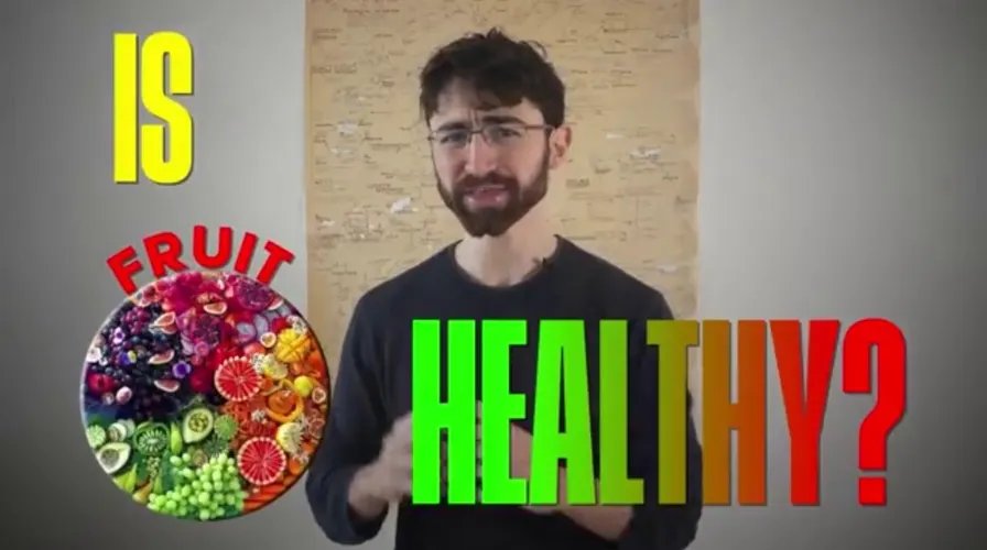 A person cutting a kiwi in half, preparing it for consumption to improve gut health.