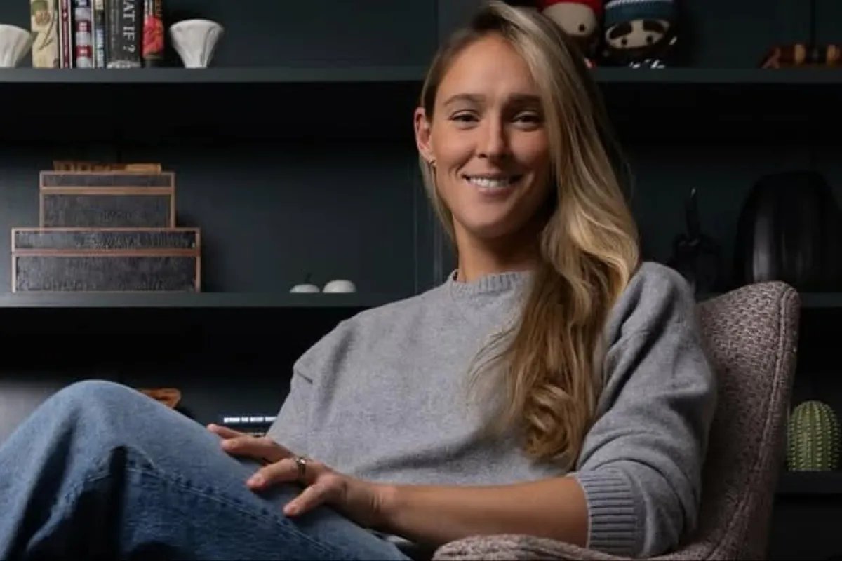 Kylie Kelce speaking passionately about youth sports at a community event.