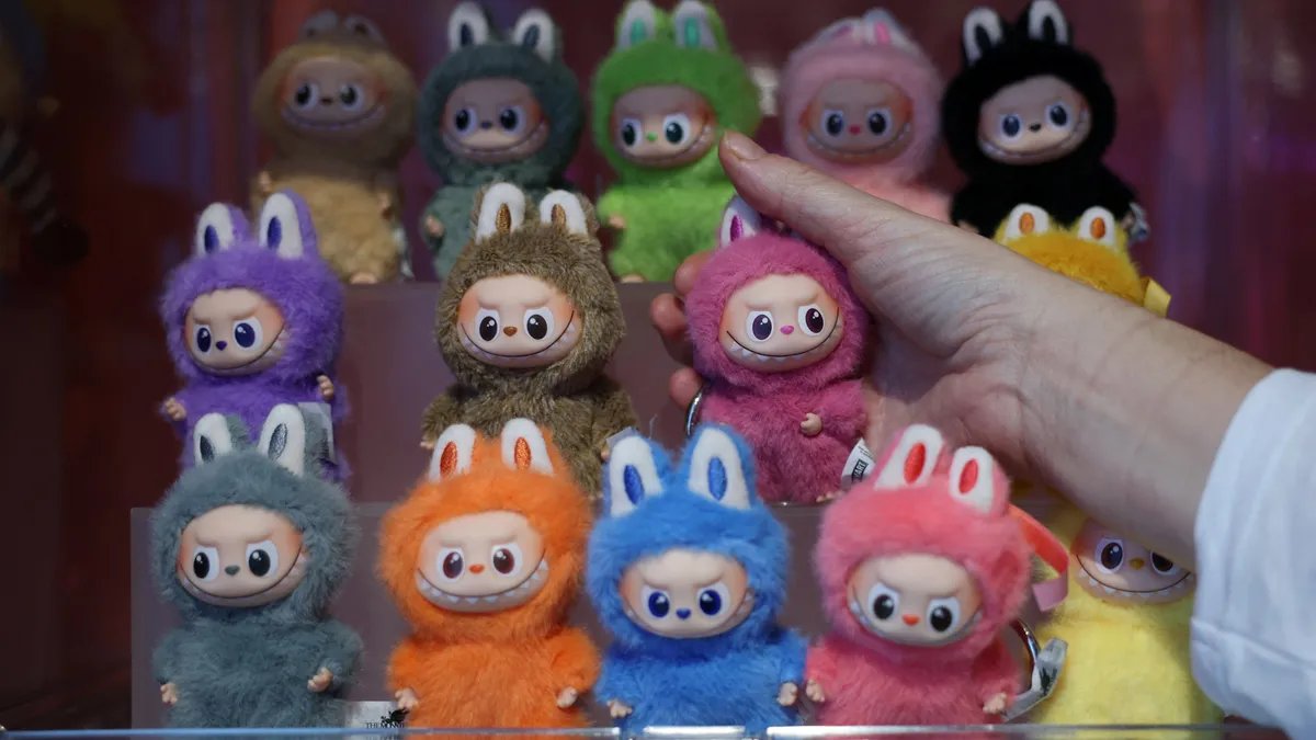 Close-up of a Labubu art toy, showcasing its distinctive elf-like ears and mischievous grin.