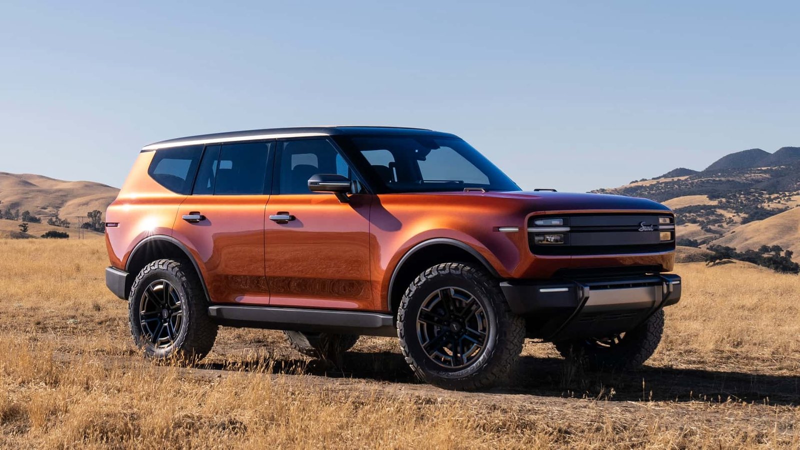 Close-up of a hand interacting with mechanical switches in a car interior, highlighting the tactile experience.