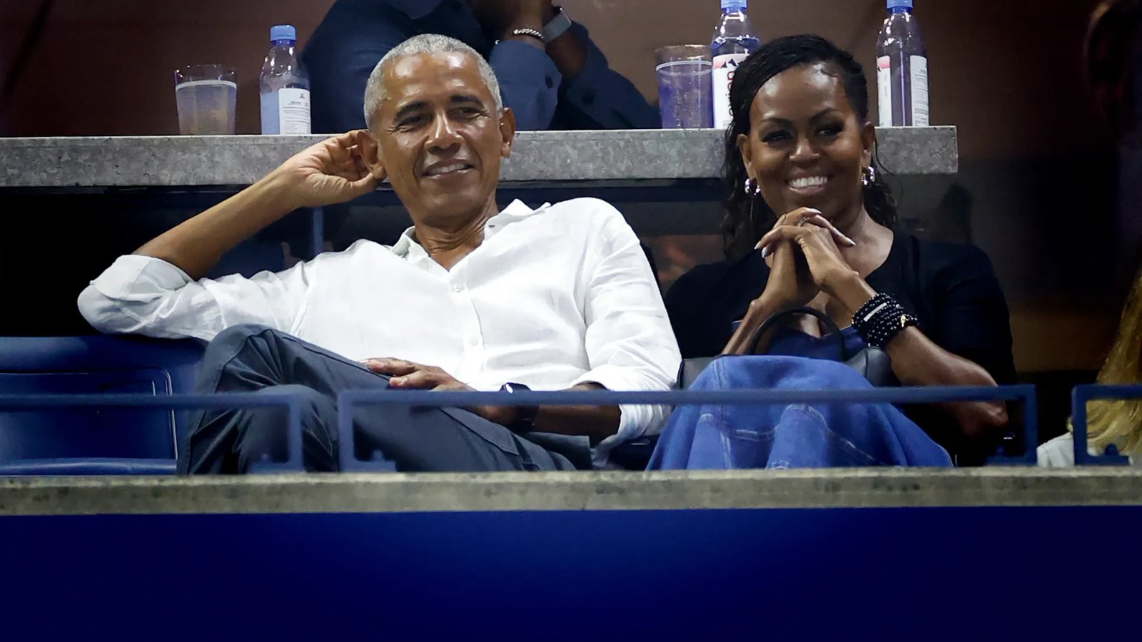 A close-up of Michelle Obama, smiling softly, with a relaxed hairstyle and minimal makeup, highlighting her natural beauty in the casual photoshoot.