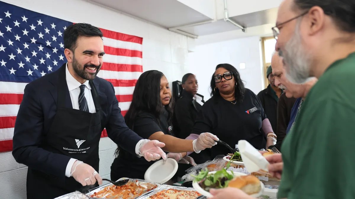 Zohran Mamdani serving food to veterans on Veteran's Day at a community event