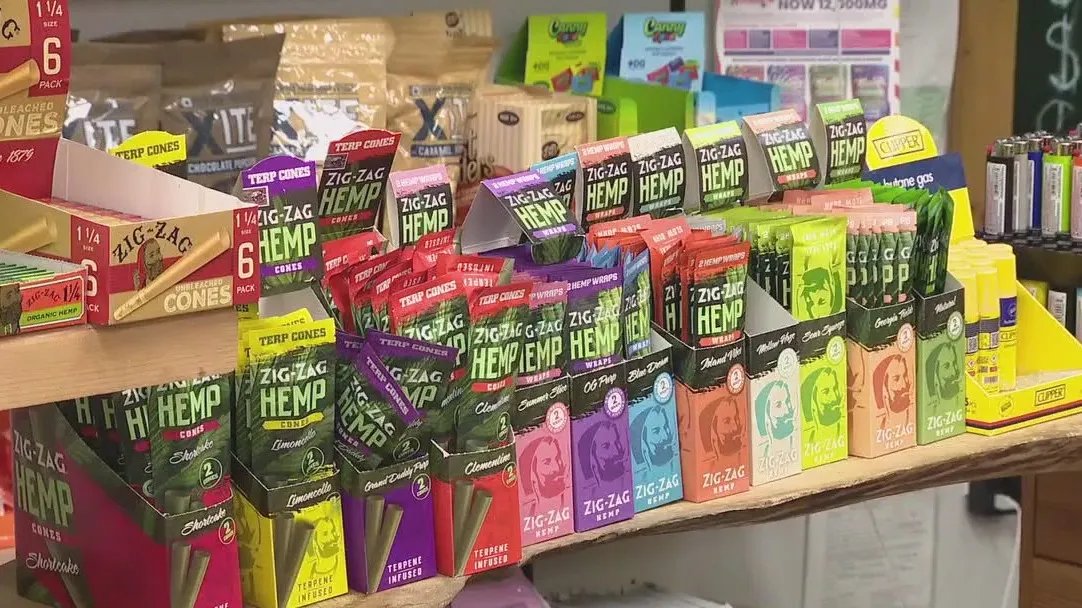 Bottles of CBD oil and gummies on a retail shelf, representing the wide range of mainstream CBD products now facing regulatory uncertainty.