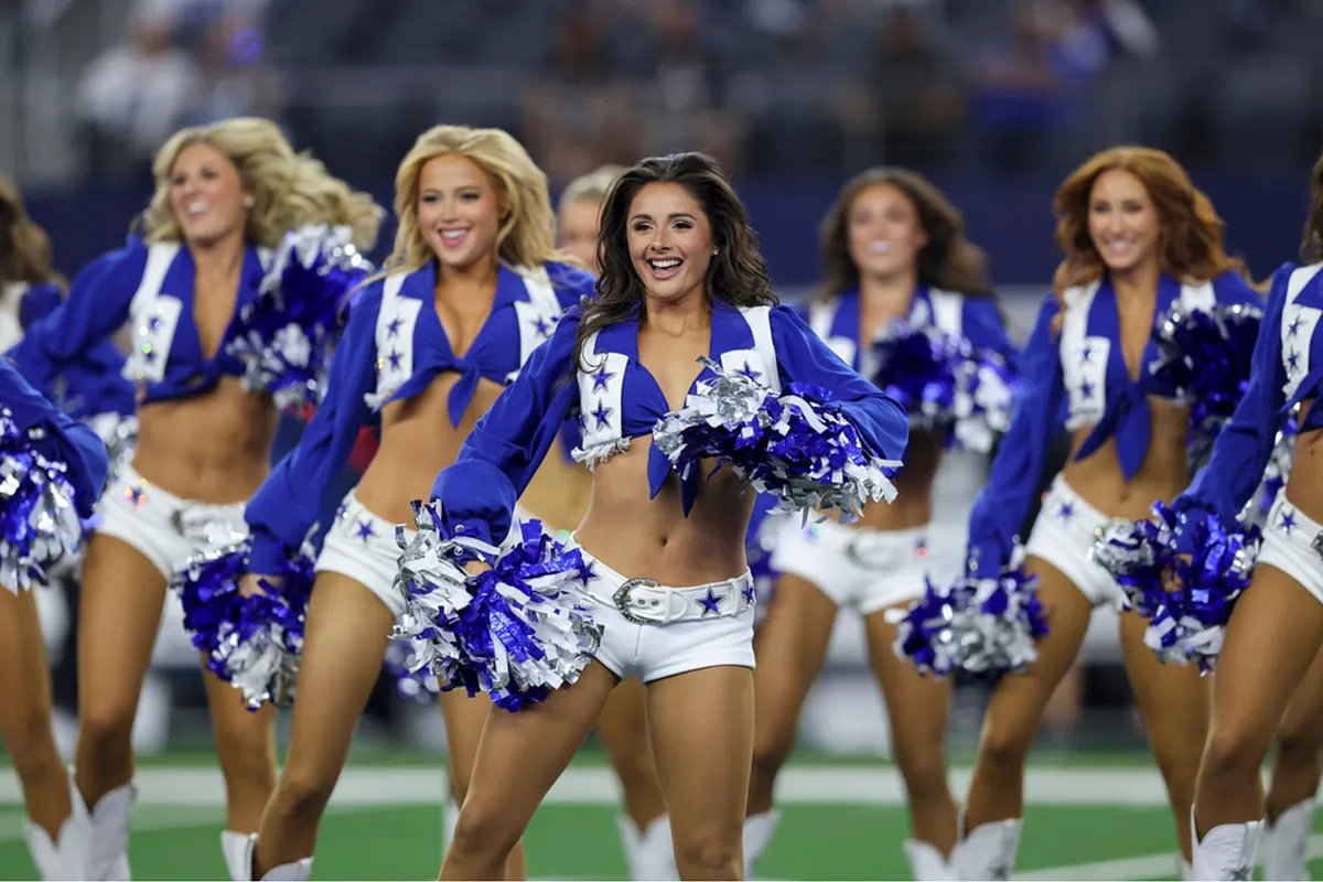 A Dallas Cowboys Cheerleader smiles brightly during a holiday performance.
