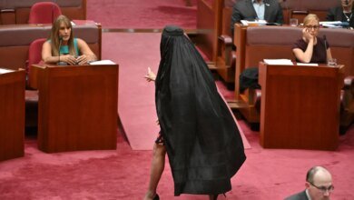 Pauline Hanson dons burqa as political prop in Australia Parliament