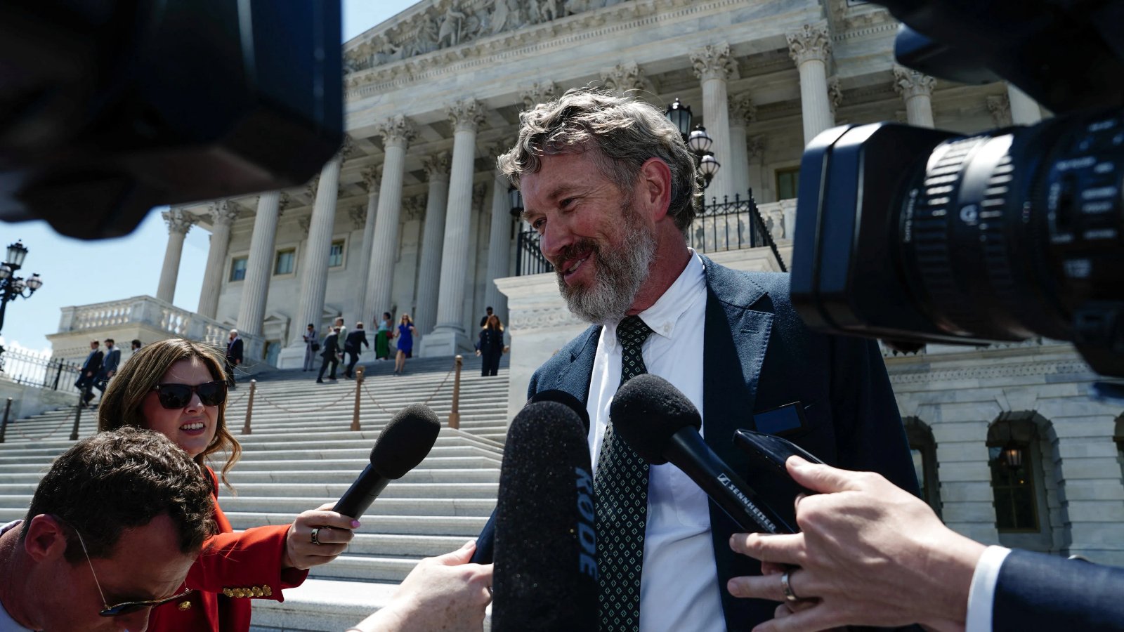 A family stands together, holding hands, with a sense of unity and purpose.