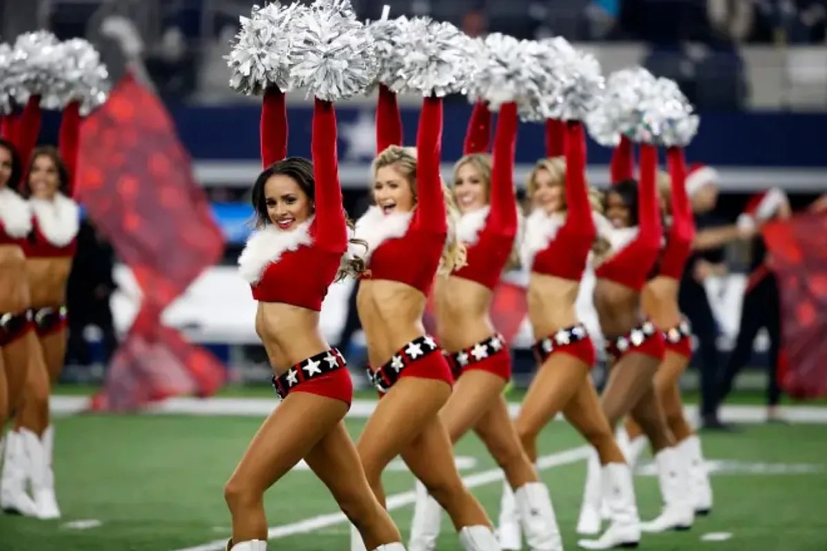 NFL Cheerleaders performing a routine on the field.