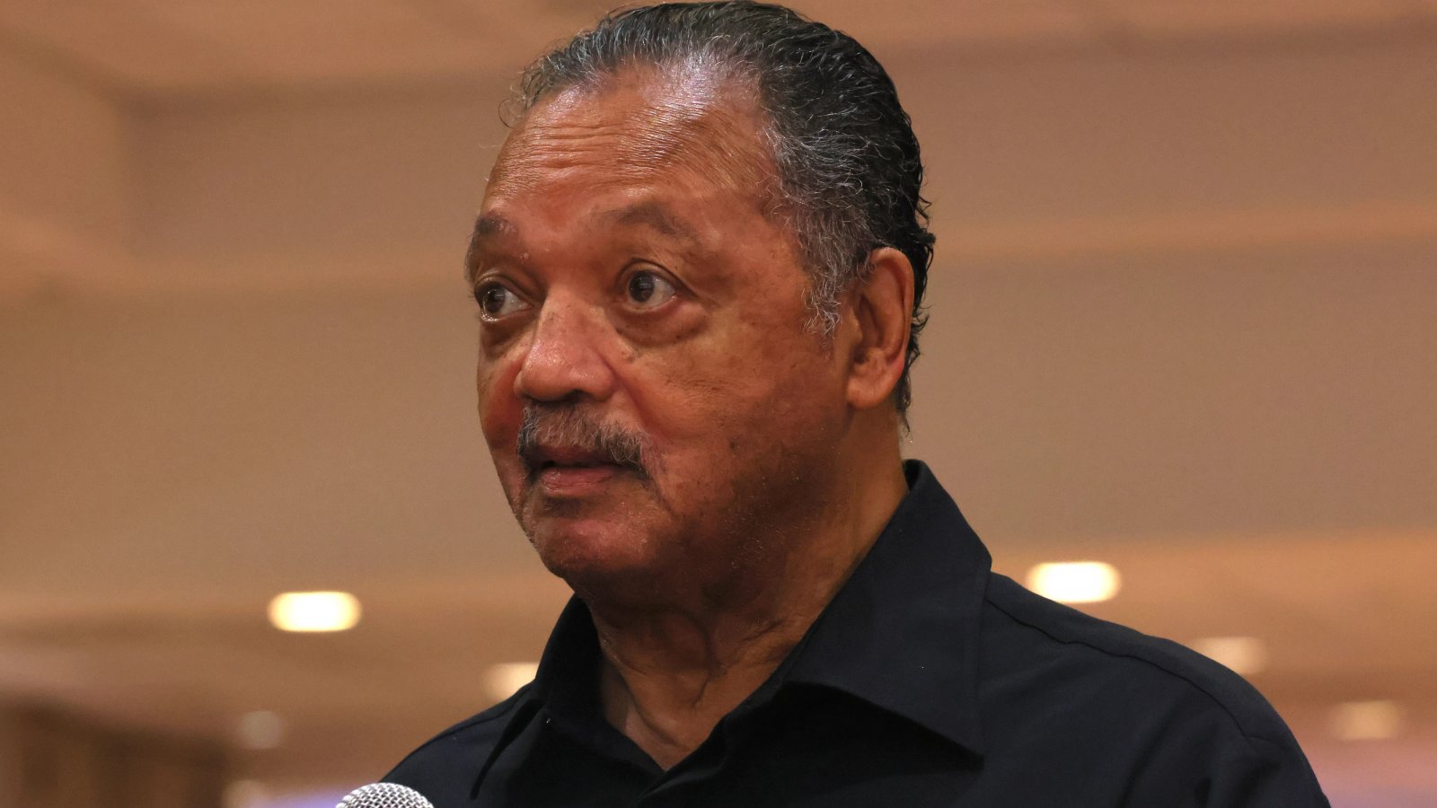 A close-up of Rev. Jesse Jackson, showing his determined expression, reflecting his decades of activism.