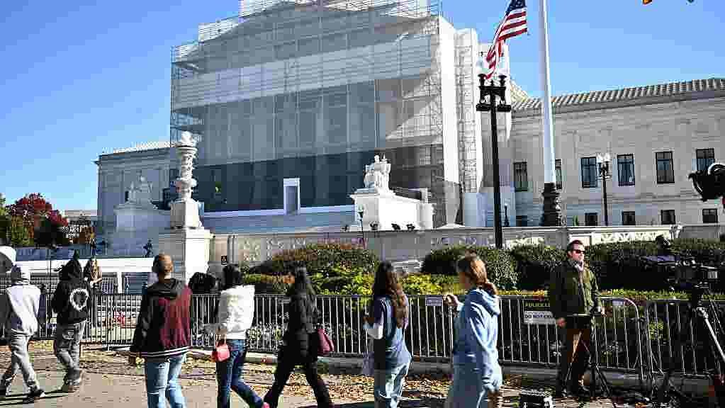 Supreme Court building with a rainbow flag, symbolizing the legal challenge to same-sex marriage.