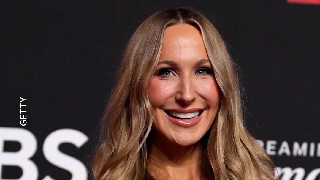 Nikki Glaser smiling on stage.