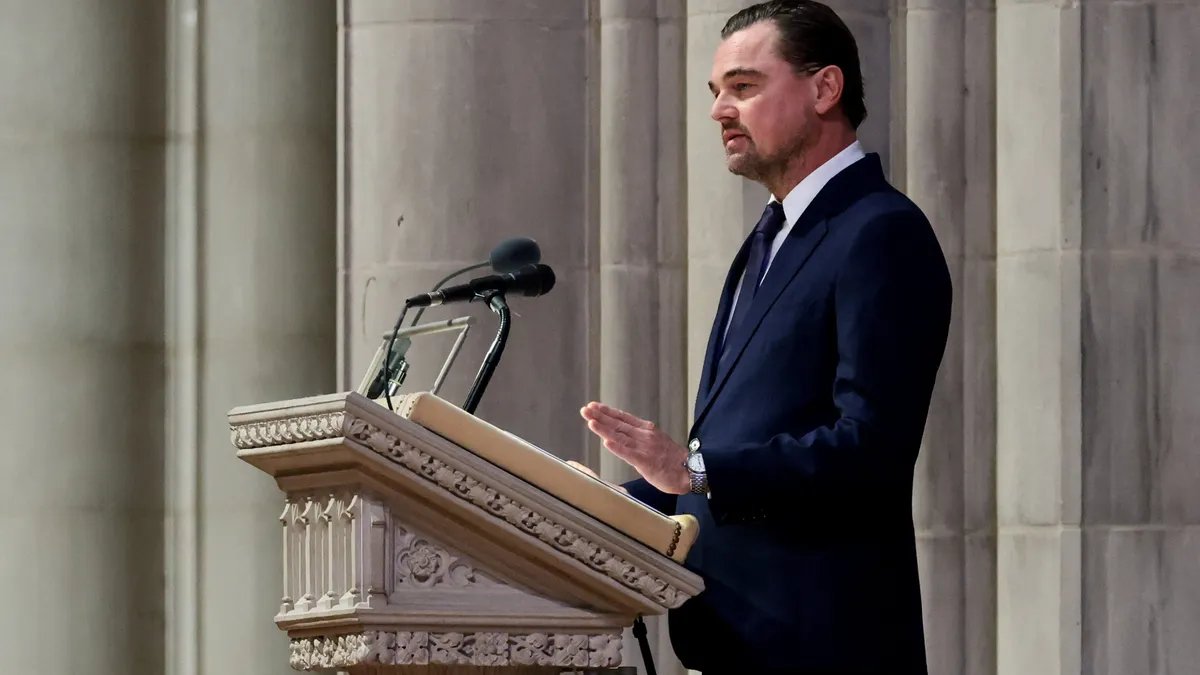 Leonardo DiCaprio and other notable attendees at Jane Goodall's Washington funeral, expressing solemn respect.