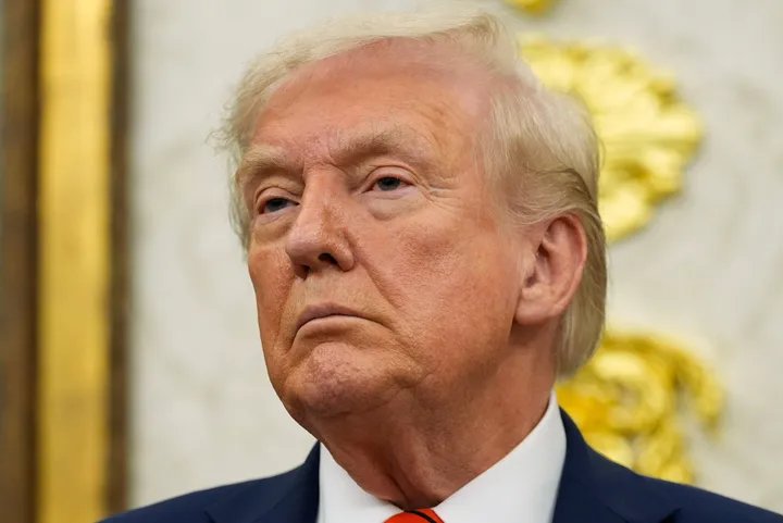 A small business owner looking worried while reviewing inventory.