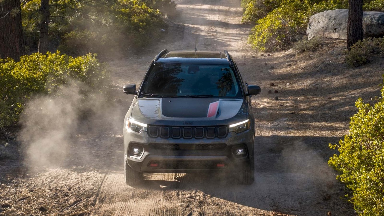 A new Jeep Renegade, representing the entry-level models, parked on a suburban street.