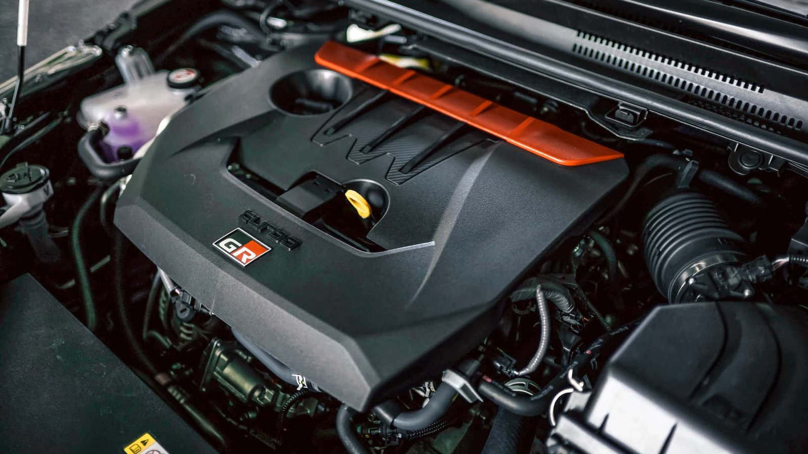 A close-up of the Toyota GR Corolla's powerful three-cylinder engine, showcasing its compact design.
