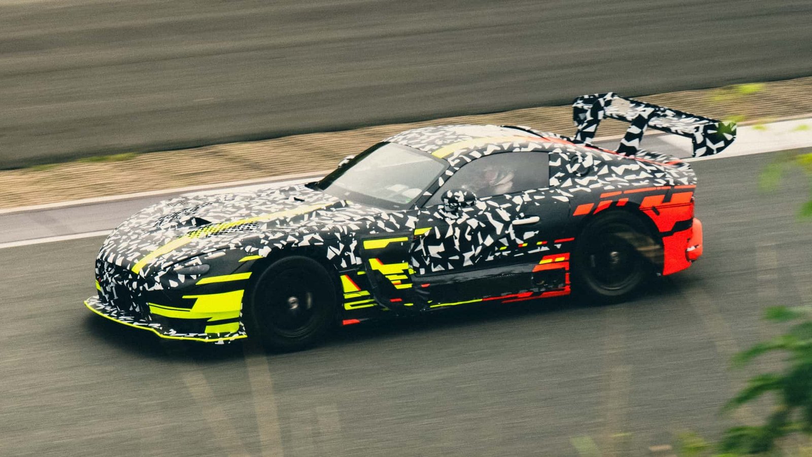 A low-angle, aggressive front view of the V-8 Mercedes-AMG GT Track Sport on a track.