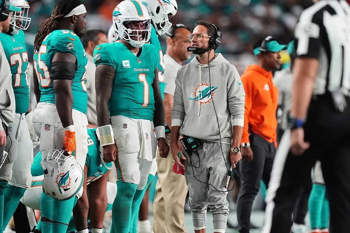 Mike McDaniel on the sidelines during a Dolphins game, looking concerned.