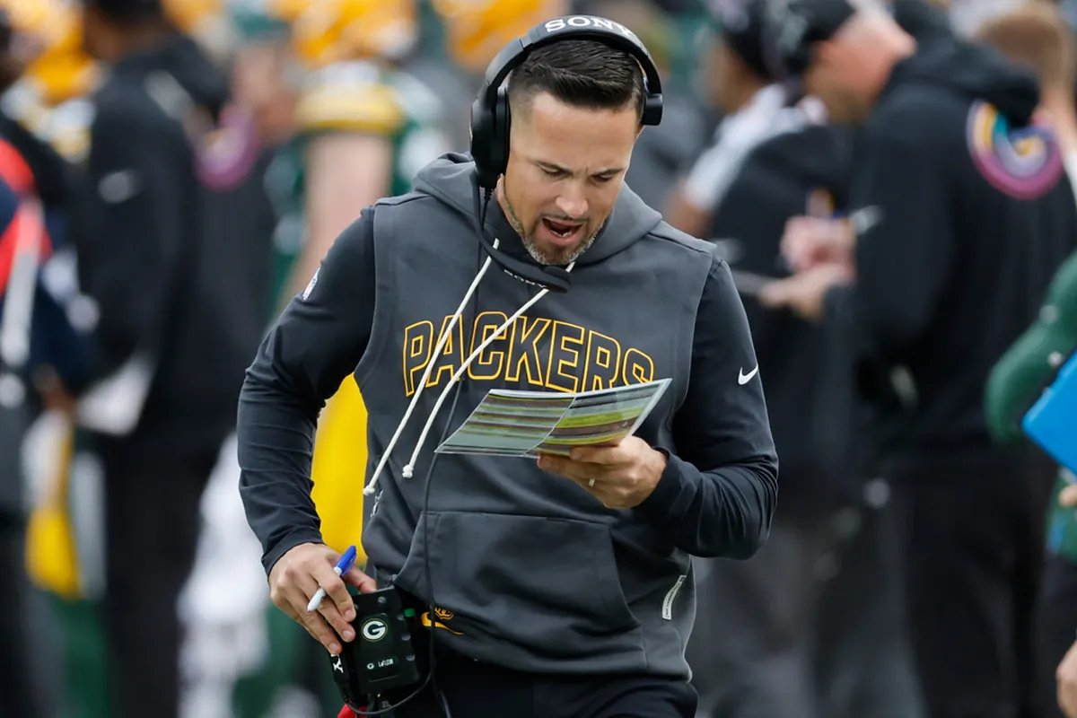Matt LaFleur looking concerned on the sidelines at Lambeau Field during a critical game.