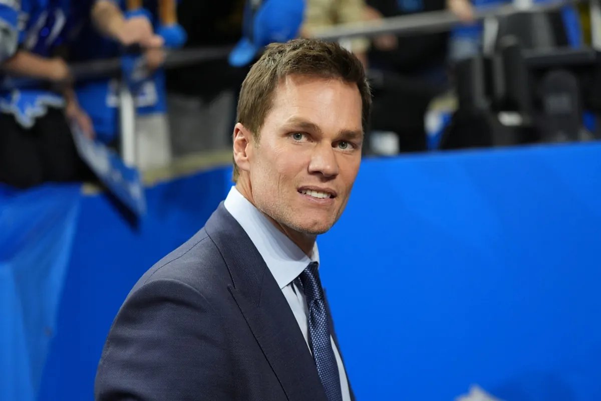 Tom Brady smiles, perhaps reflecting on a fortunate escape from a struggling franchise.