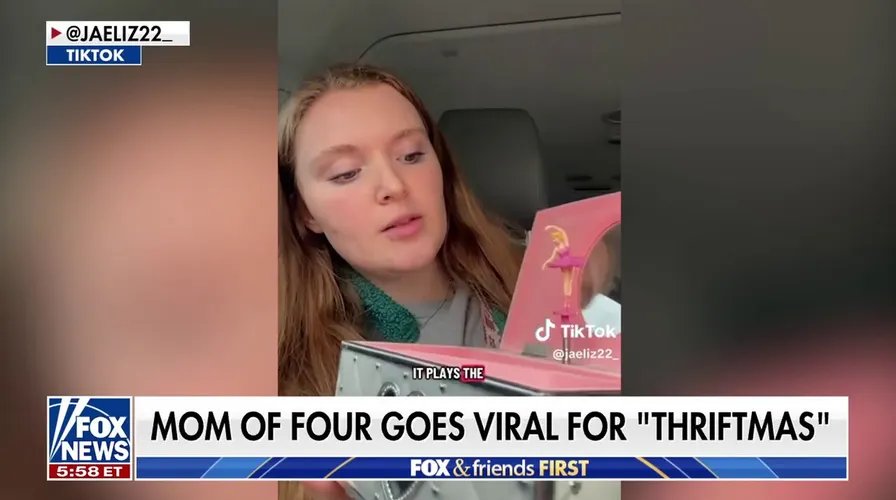 A close-up of a brightly decorated artificial Christmas tree on display in a store.