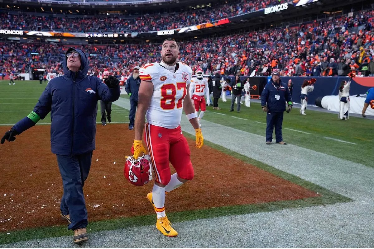 Travis Kelce on the sidelines, conveying intense emotion during a challenging game.