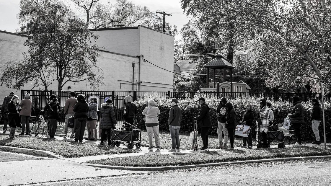A family looking worriedly at an empty refrigerator, symbolizing America's hunger crisis.