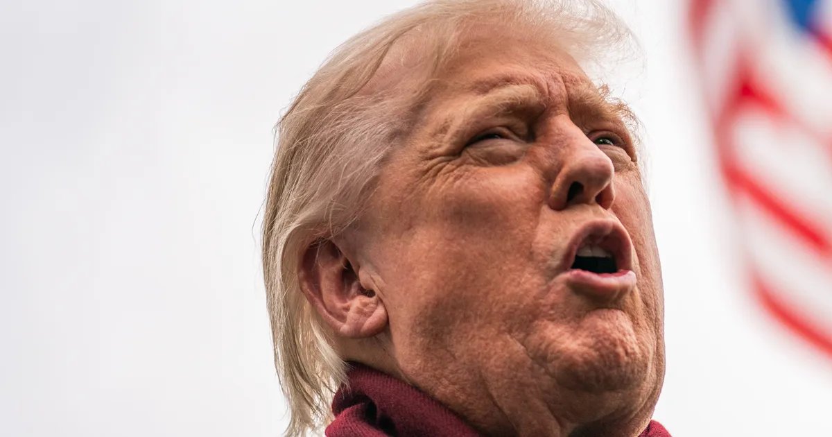 Donald Trump smiling in a meeting, with film reels and a director's chair visible in the background.