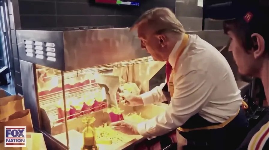 A busy McDonald's kitchen with fry baskets, symbolizing humble beginnings.