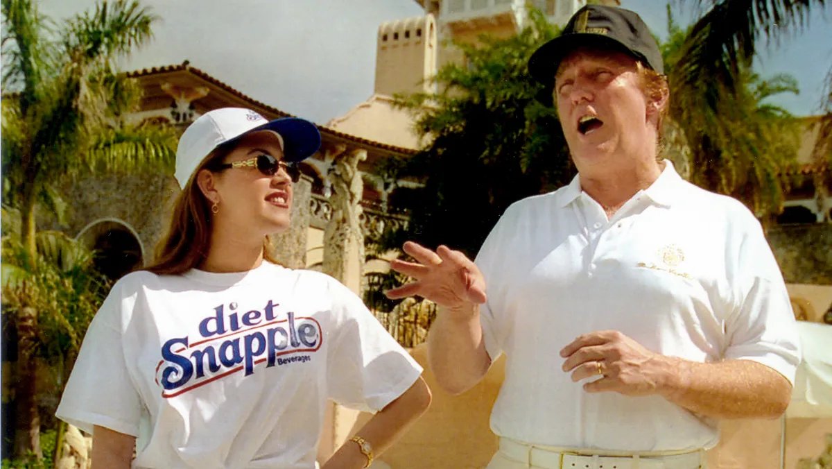 Donald Trump speaking at a rally, looking directly at the audience with a serious expression.