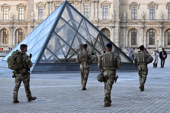 Forensic investigators at the scene of the Louvre heist