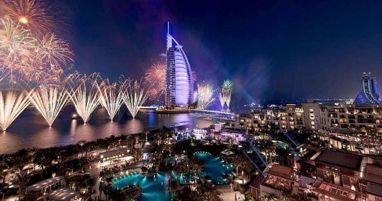 Fireworks exploding over the Dubai skyline during a National Day celebration.