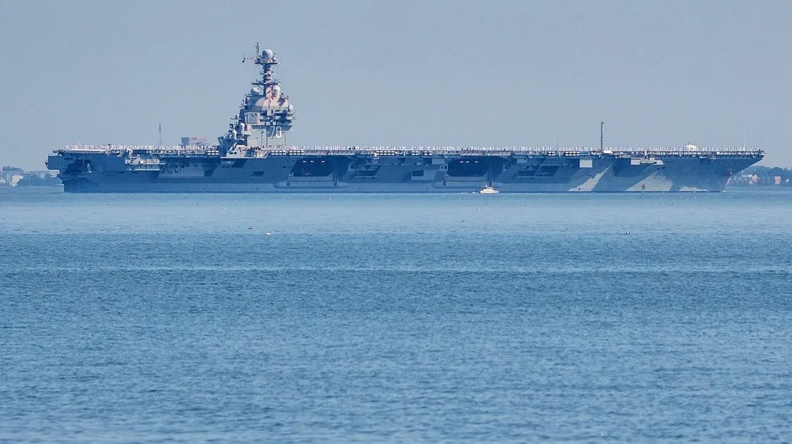 The USS George Washington aircraft carrier steaming through open waters.