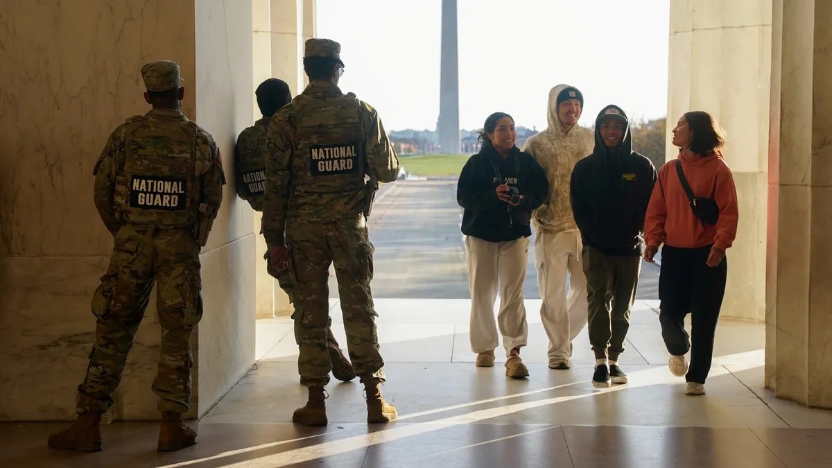 A roadside memorial with flowers and a US flag.
