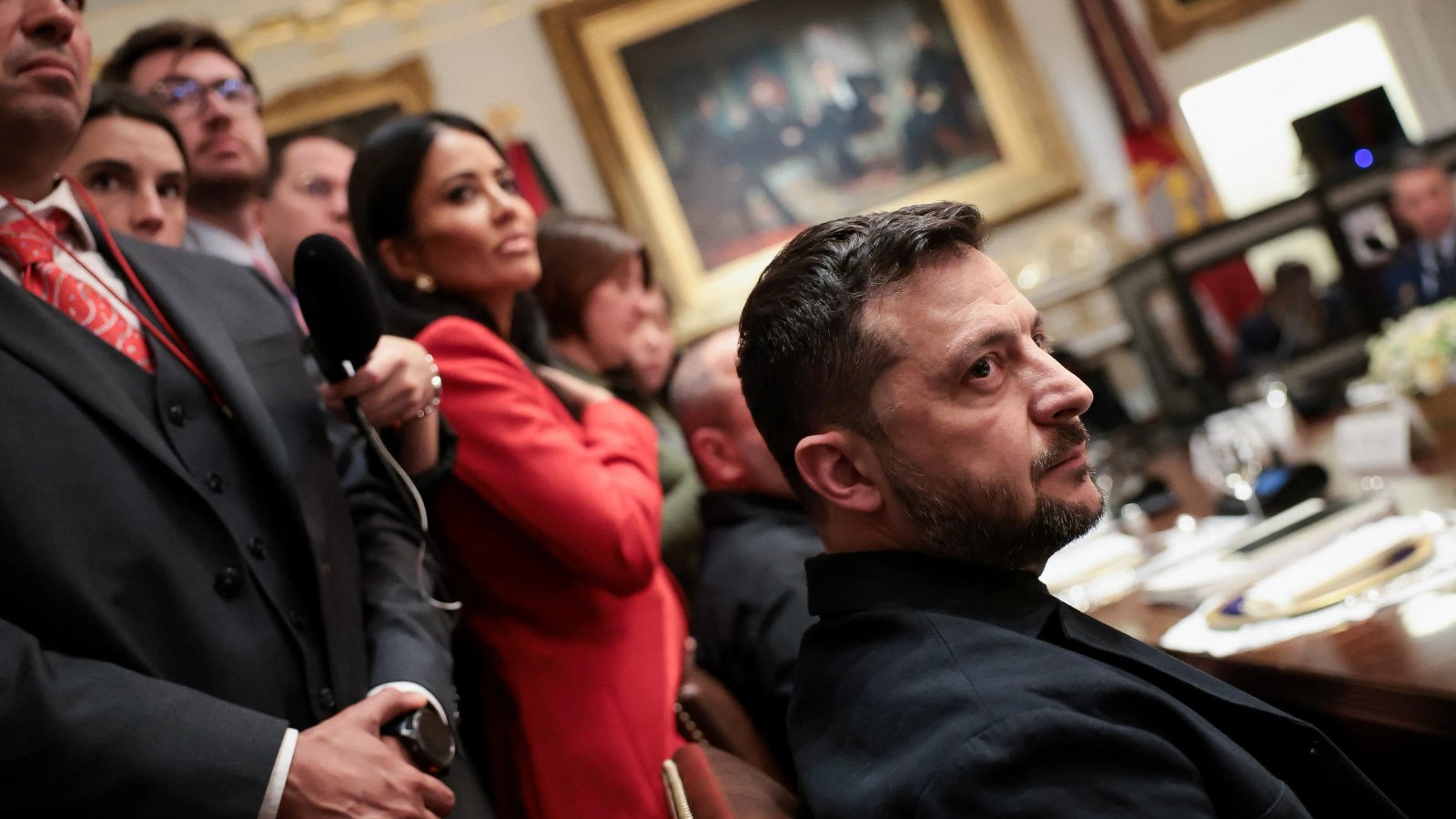 A close-up of a serious-looking diplomat listening intently.