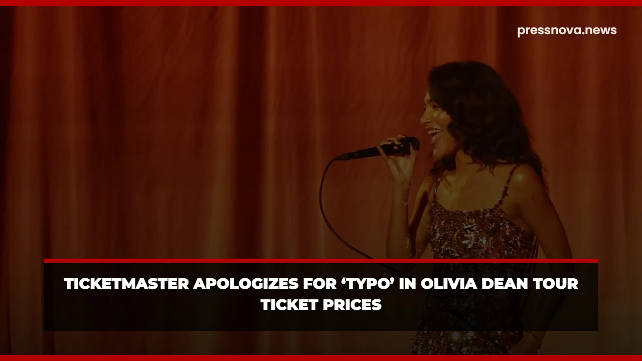 Olivia Dean performing live on stage, bathed in vibrant lighting.