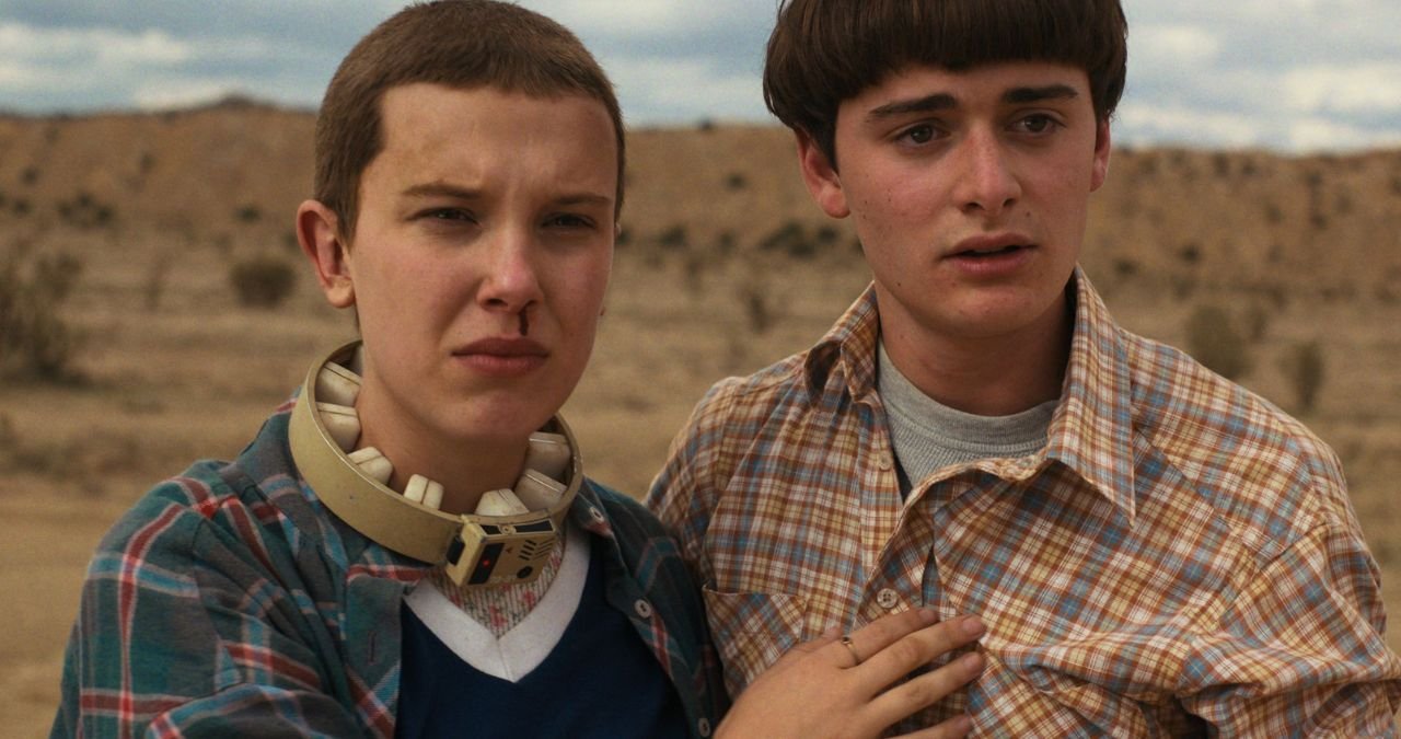 Stranger Things cast posing in front of a dark and mysterious background with red lightning.
