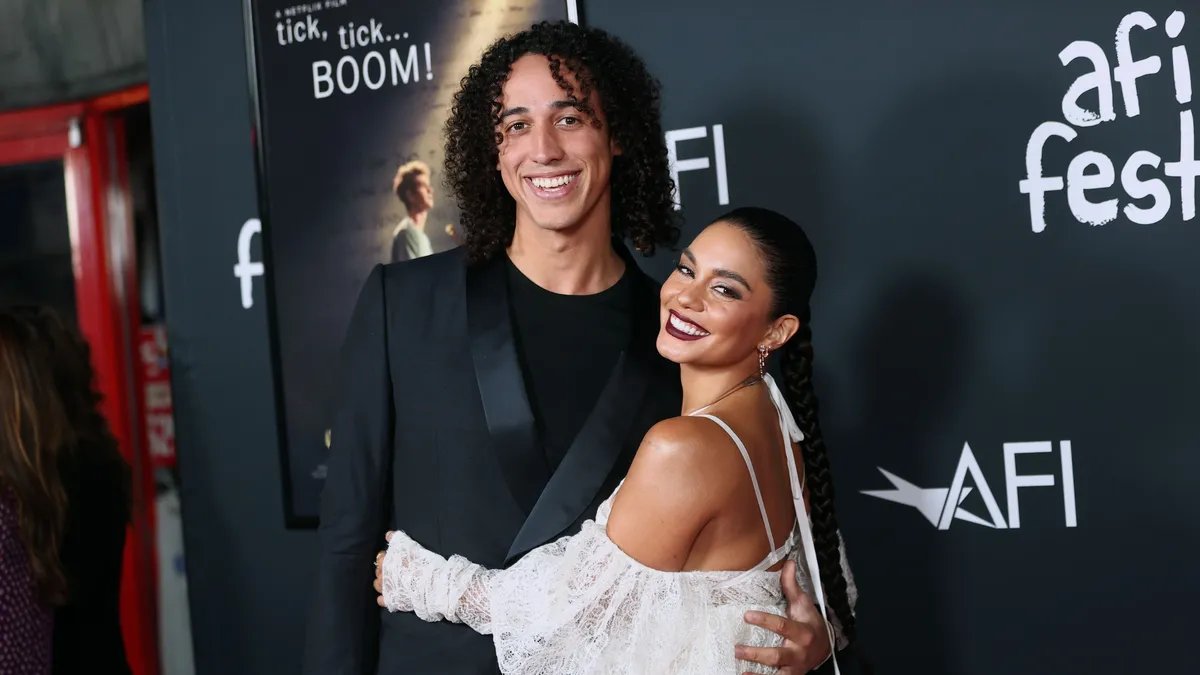 Vanessa Hudgens and Cole Tucker posing for a family photo with their first child.
